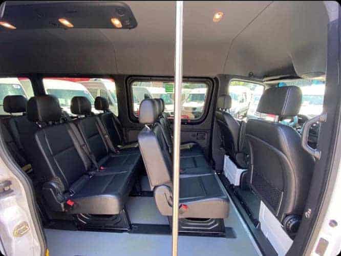 Interior of passenger van with multiple rows of seats