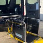 Van with deployed wheelchair lift platform at rear