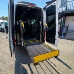 Accessible van with deployed wheelchair ramp at rear