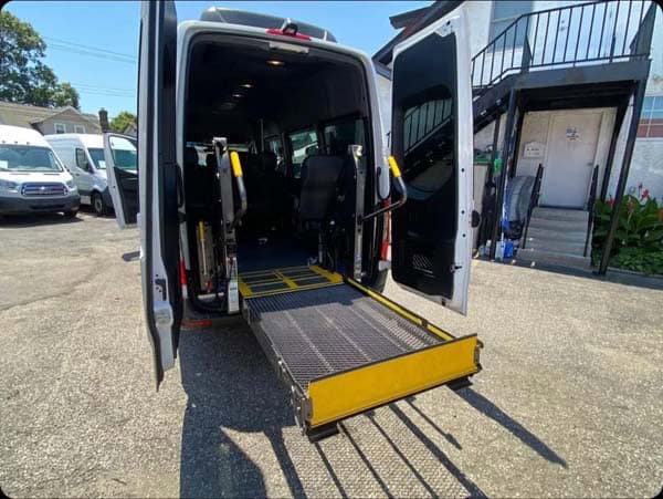 Accessible van with deployed wheelchair ramp at rear