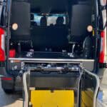 Rear van with deployed wheelchair lift platform