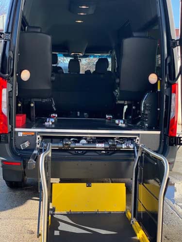 Rear van with deployed wheelchair lift platform