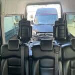 Interior of passenger van with Mercedes outside rear