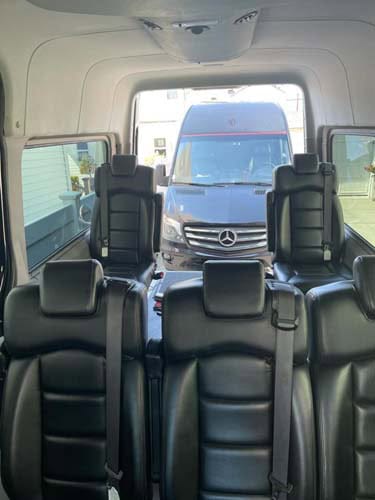 Interior of passenger van with Mercedes outside rear