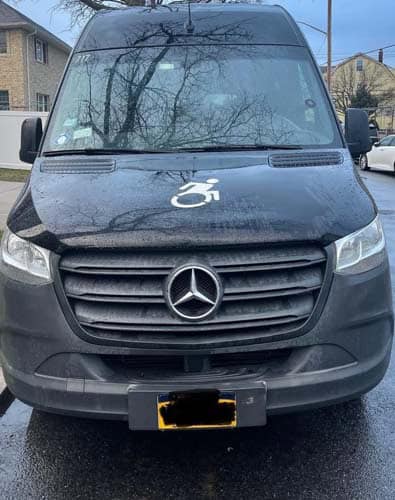 Front view of Mercedes van with wheelchair symbol.