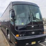 Black coach bus parked on city street