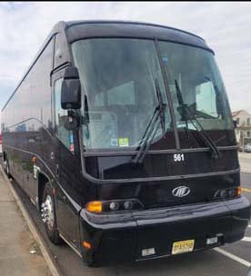 Black coach bus parked on city street