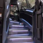 Illuminated bus entry steps leading to driver seat