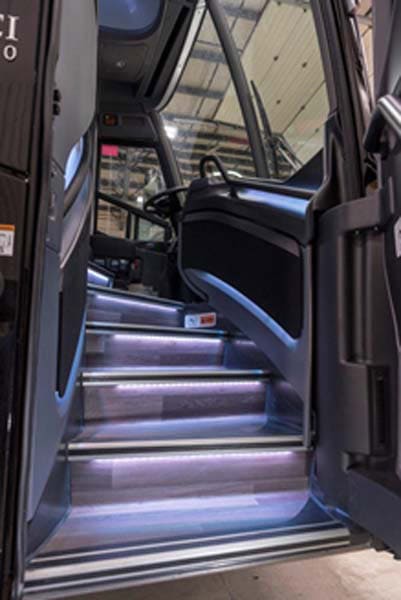 Illuminated bus entry steps leading to driver seat