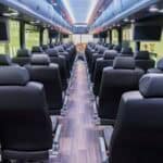 Interior of modern passenger train car with black seats