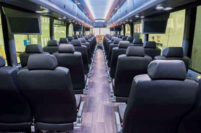 Interior of modern passenger train car with black seats