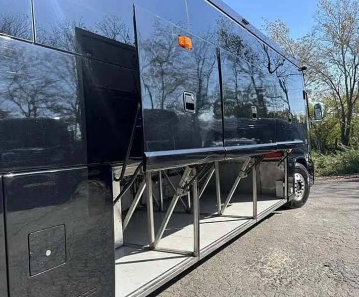 Luxury bus with extended undercarriage storage compartments open