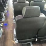 Interior of bus with black seats and aisle
