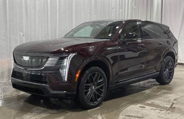 Dark maroon Cadillac SUV in indoor showroom