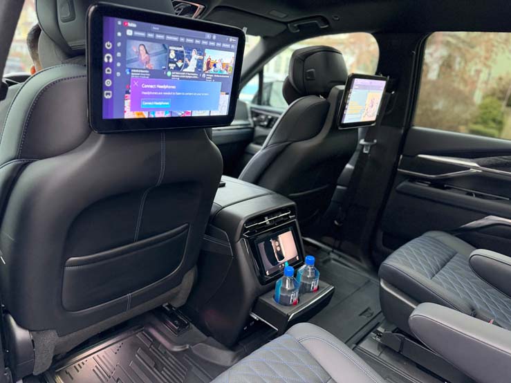 Luxury SUV rear cabin with headrest entertainment screens