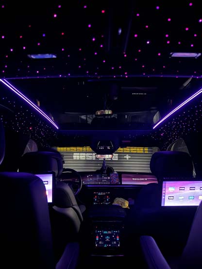 Luxury car interior with purple LED starlight ceiling