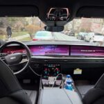 Cadillac Escalade interior with dashboard screens and street view