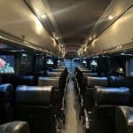 Luxury coach interior with leather seats and screens