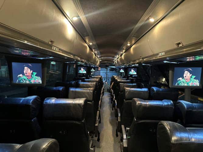 Luxury coach interior with leather seats and screens