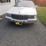 Front view of white vintage Cadillac sedan