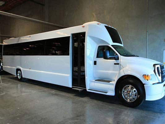 White stretch limousine bus parked indoors