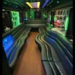 Neon-lit party bus interior with curved seating