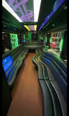 Neon-lit party bus interior with curved seating