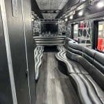 Luxury party bus interior with curved leather seating