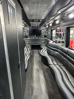 Luxury party bus interior with curved leather seating