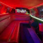 Red neon-lit limousine interior with leather seating
