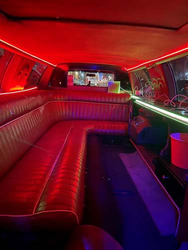 Red neon-lit limousine interior with leather seating