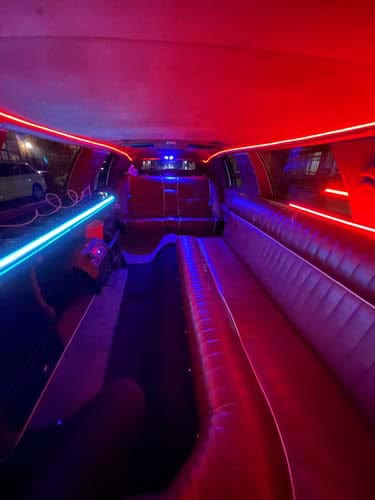 Neon-lit limousine interior with leather seating