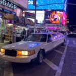 White stretch limousine in Times Square at night