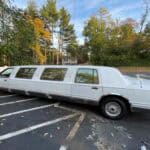 Long white stretch limousine parked in lot