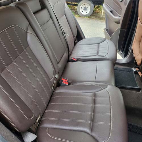 Brown leather rear bench seat in vehicle interior