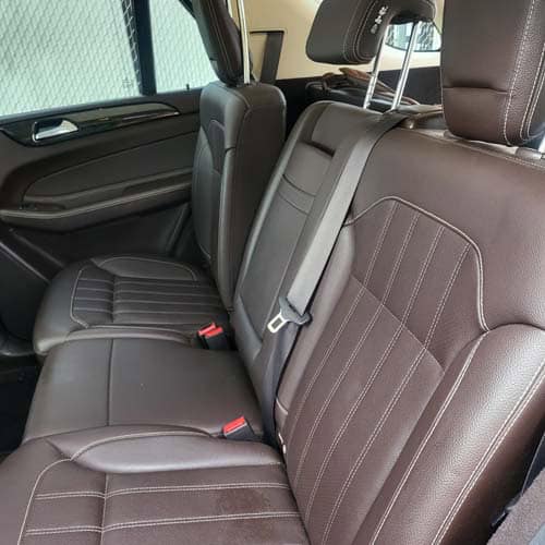 Brown leather car back seats with seatbelts