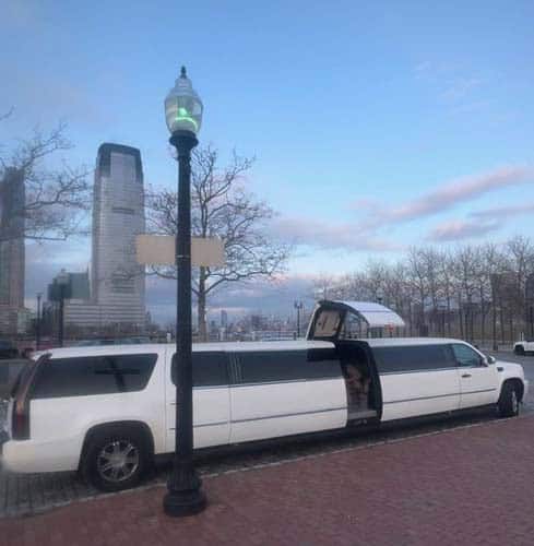 White stretch limousine parked on city street