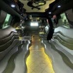 Luxury limousine interior with curved leather seating and LED lighting