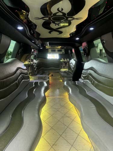 Luxury limousine interior with curved leather seating and LED lighting