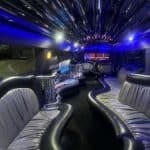 Luxury limousine interior with blue lighting and leather seats