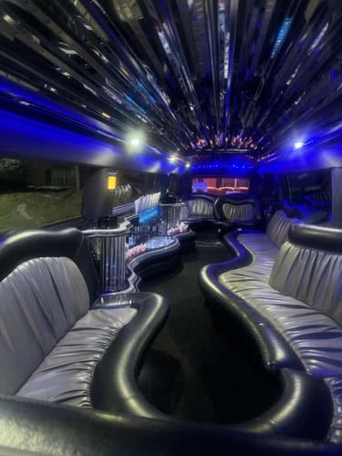 Luxury limousine interior with blue lighting and leather seats