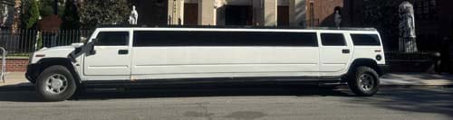 White stretch limousine parked on city street