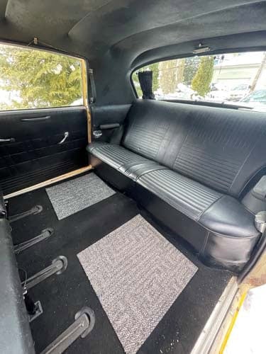 Vintage car interior with black rear bench seat