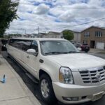 White Cadillac Escalade stretch limousine parked on residential street