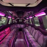 Luxury limousine interior with pink LED lighting and leather seats