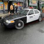 Black and white police car parked on city street