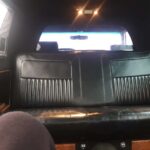 Black leather rear bench seat inside limousine interior