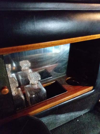 Vintage car door compartment with crystal perfume bottles