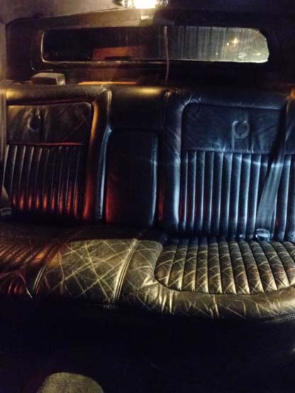 Black leather rear seats inside a vintage car