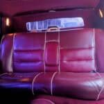 Burgundy leather backseat inside vintage car interior